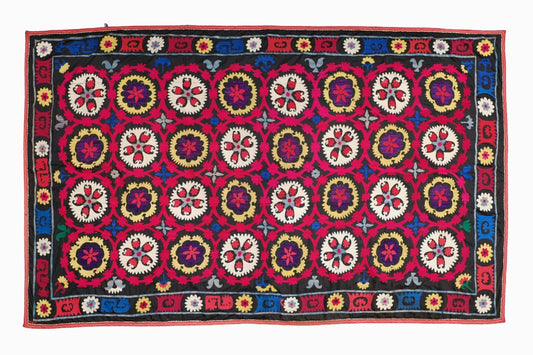 A multicoloured Suzani on a black background