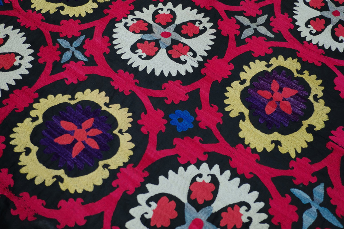 A multicoloured Suzani on a black background