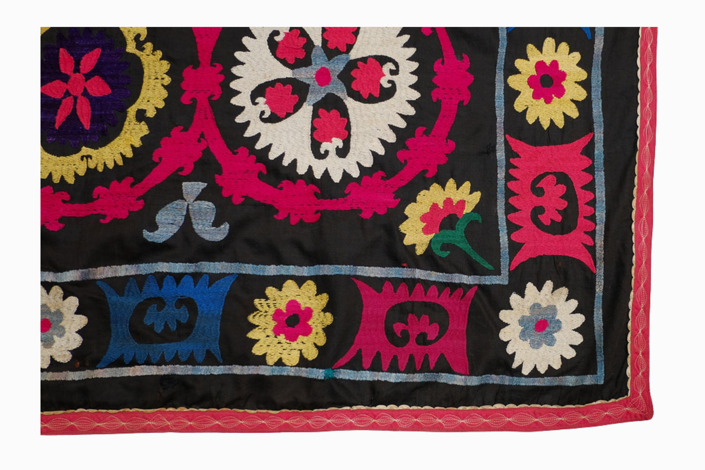 A multicoloured Suzani on a black background