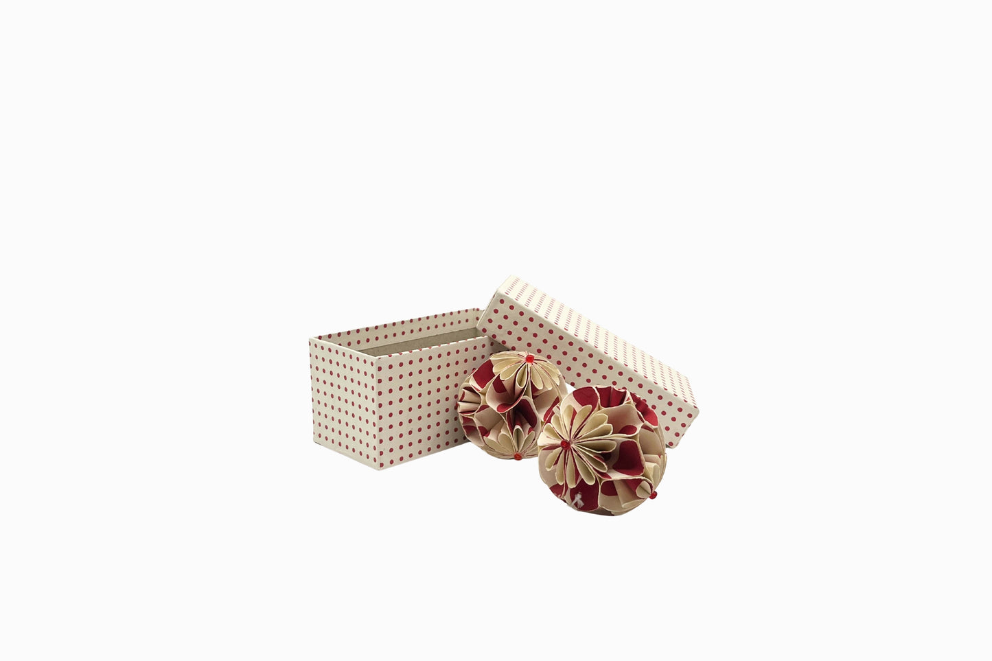 A pair of red and cream paper baubles