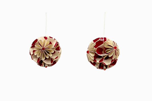A pair of red and cream paper baubles