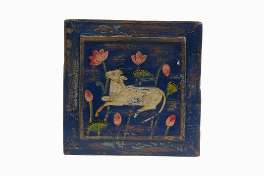 A reclining Holy Cow with flowers