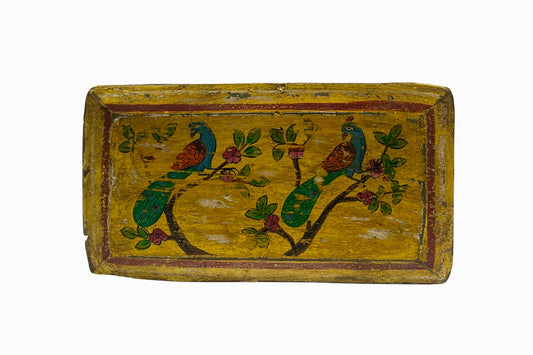 A yellow painted panel picture with two peacocks