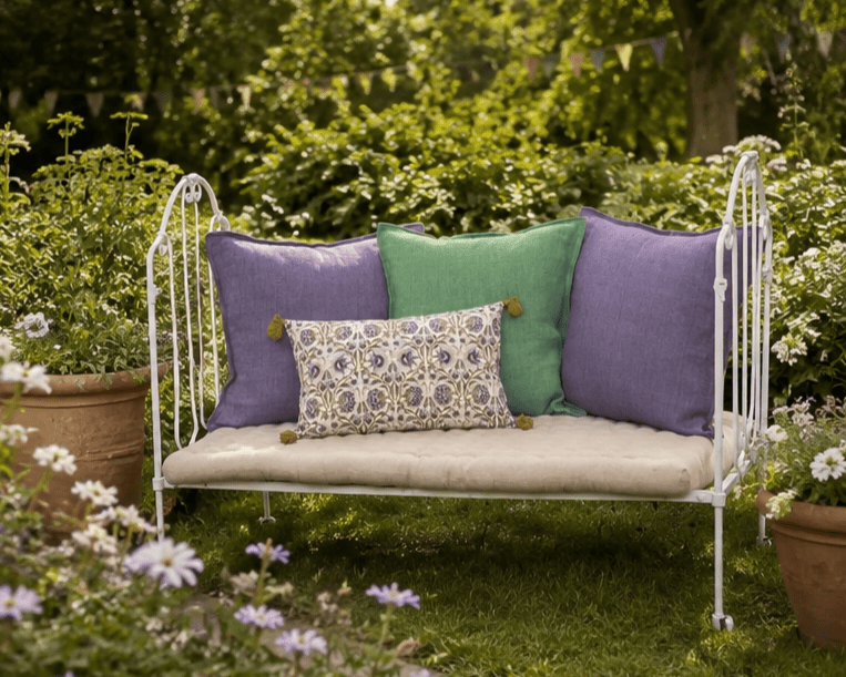 A vintage French folding wrought iron seat