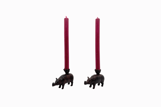 A pair of metal rhino candlesticks