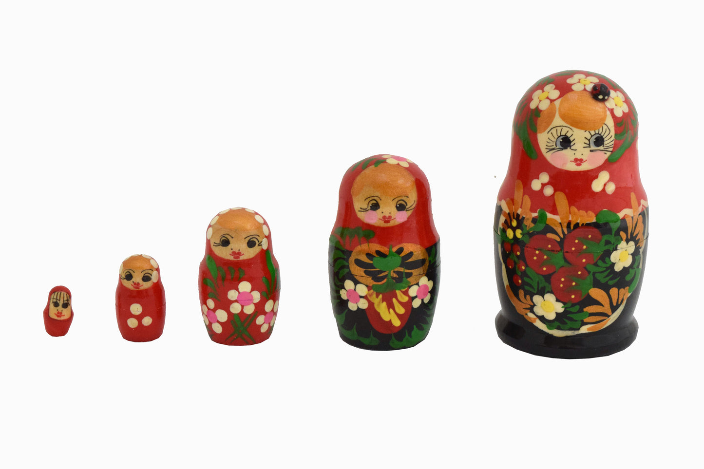 Conjunto de muñecas rusas de madera rojas y negras.