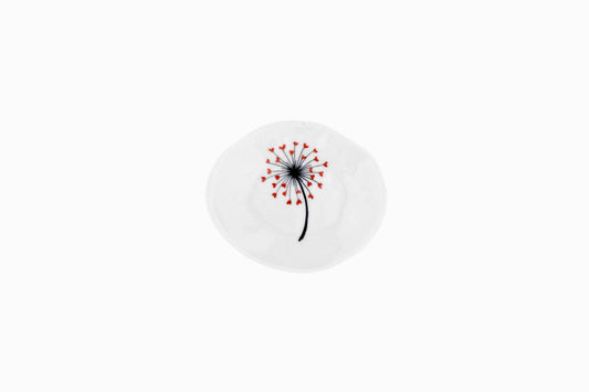 Tiny porcelain dish with a dandelion