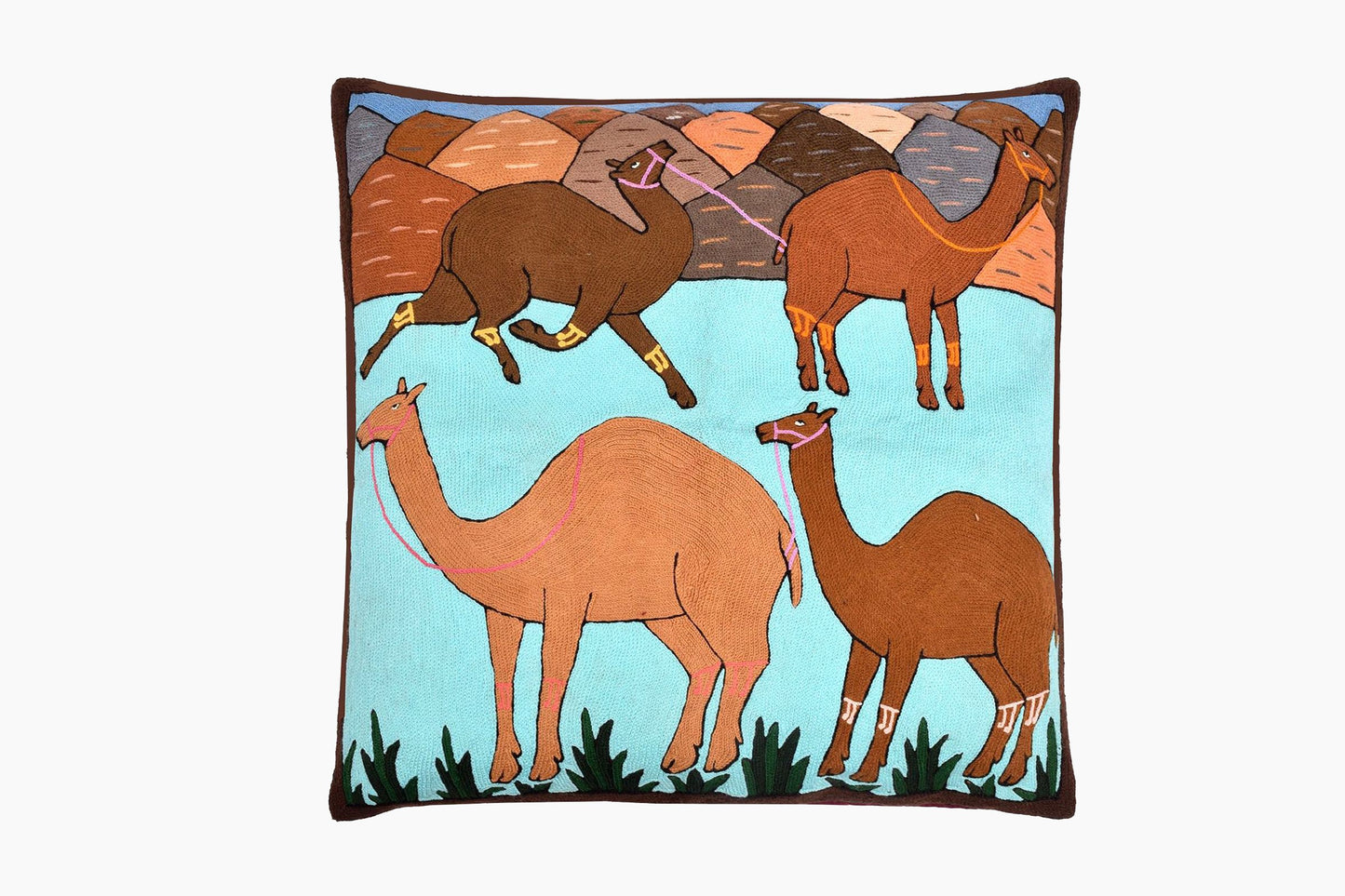 A COLOURFUL FLOOR CUSHION EMBROIDERED WITH CAMELS