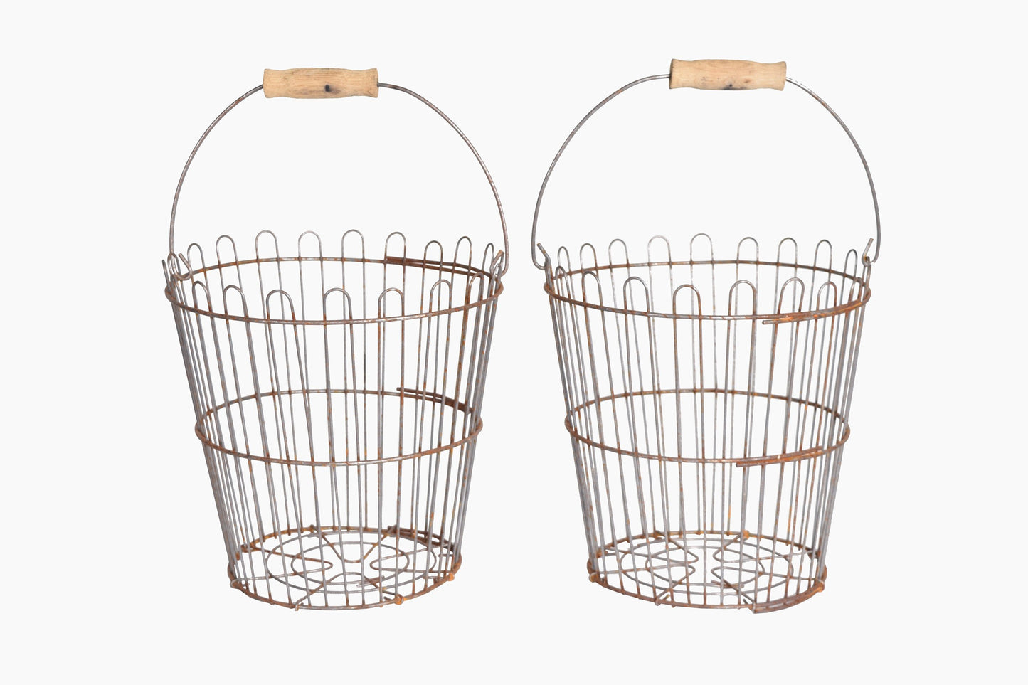 A pair of metal wire baskets with wooden handles